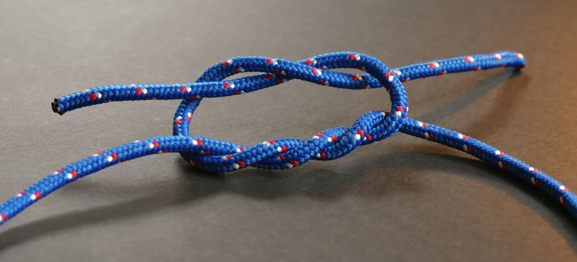 Step-by-step diagram of surgeon's knot tying sequence with doubled first throw followed by single throws