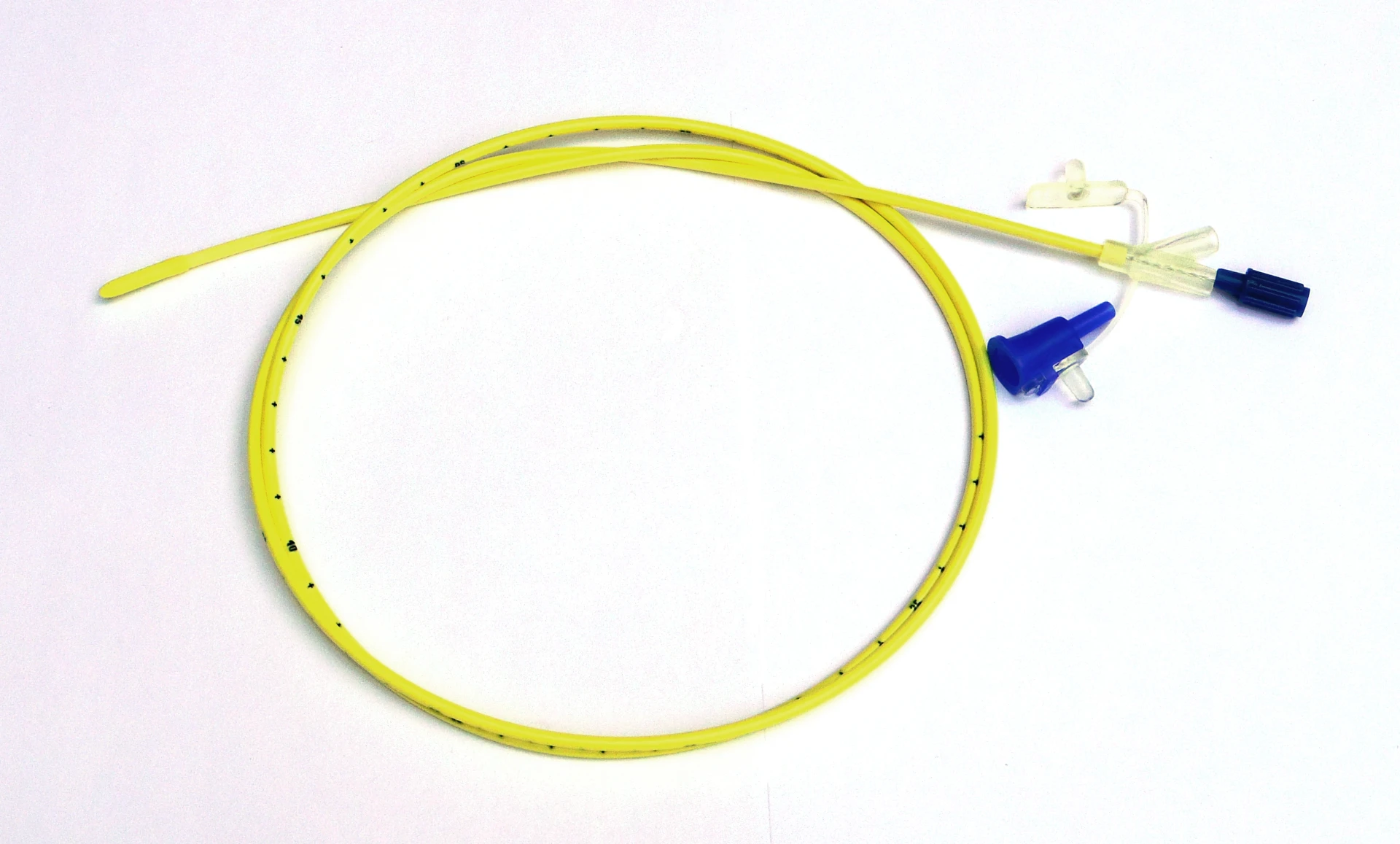 Small-bore weighted enteral feeding tube with stylet partially withdrawn — distal-tip detail