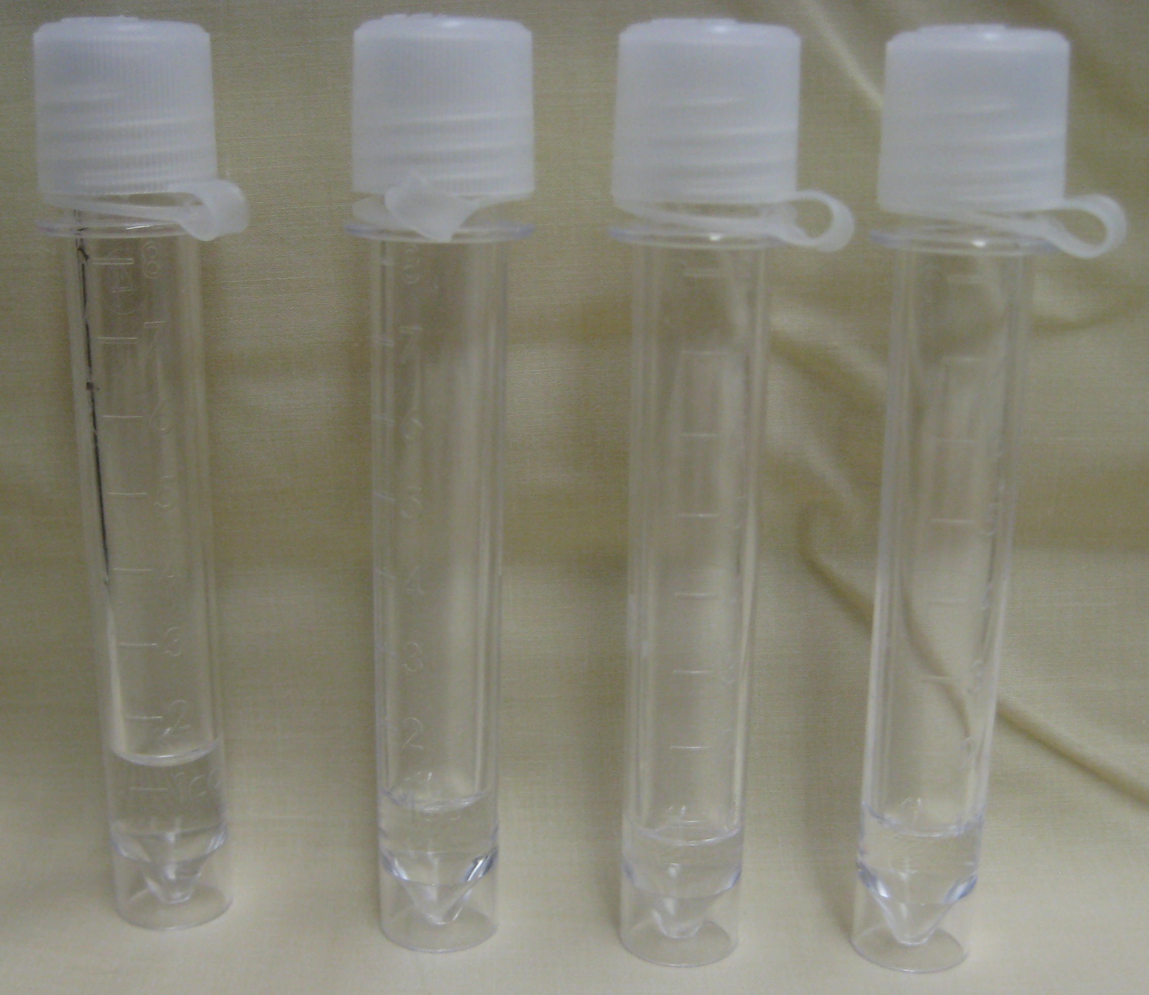 Four numbered vials of clear human cerebrospinal fluid from a lumbar puncture